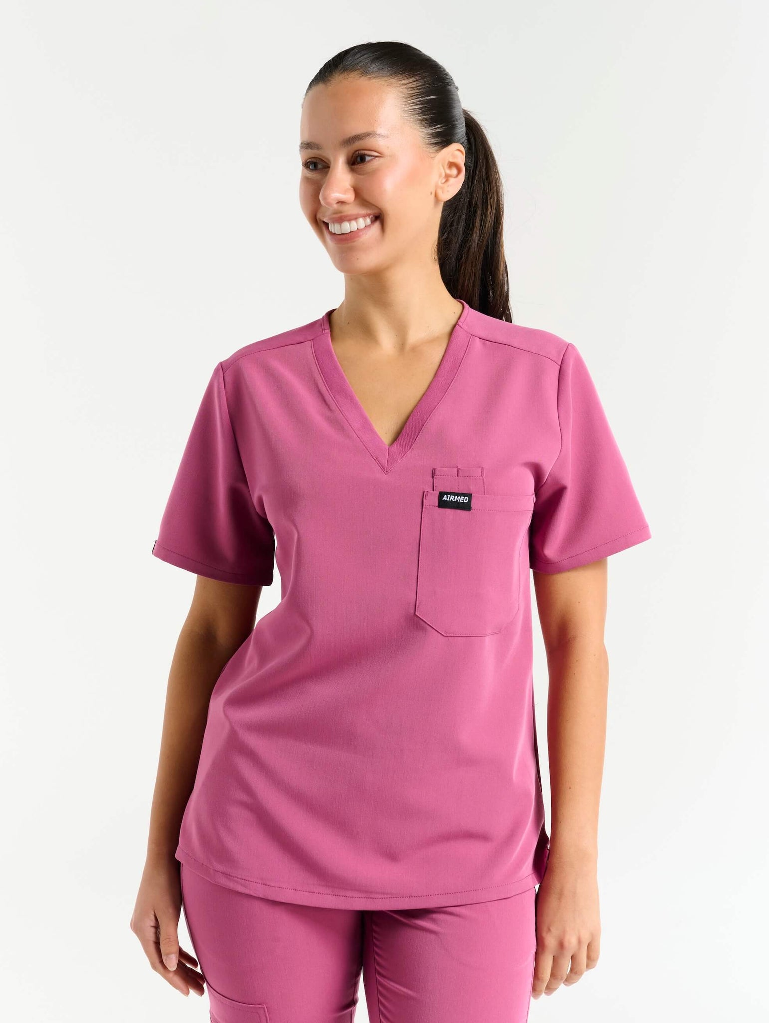 back view of red violet one pocket v neck scrub top