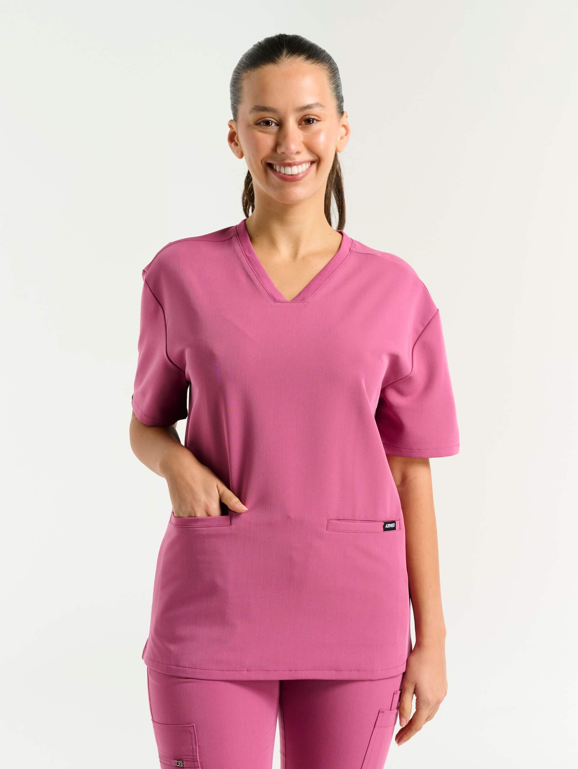 close up of pocket detail of red violet v neck scrub top