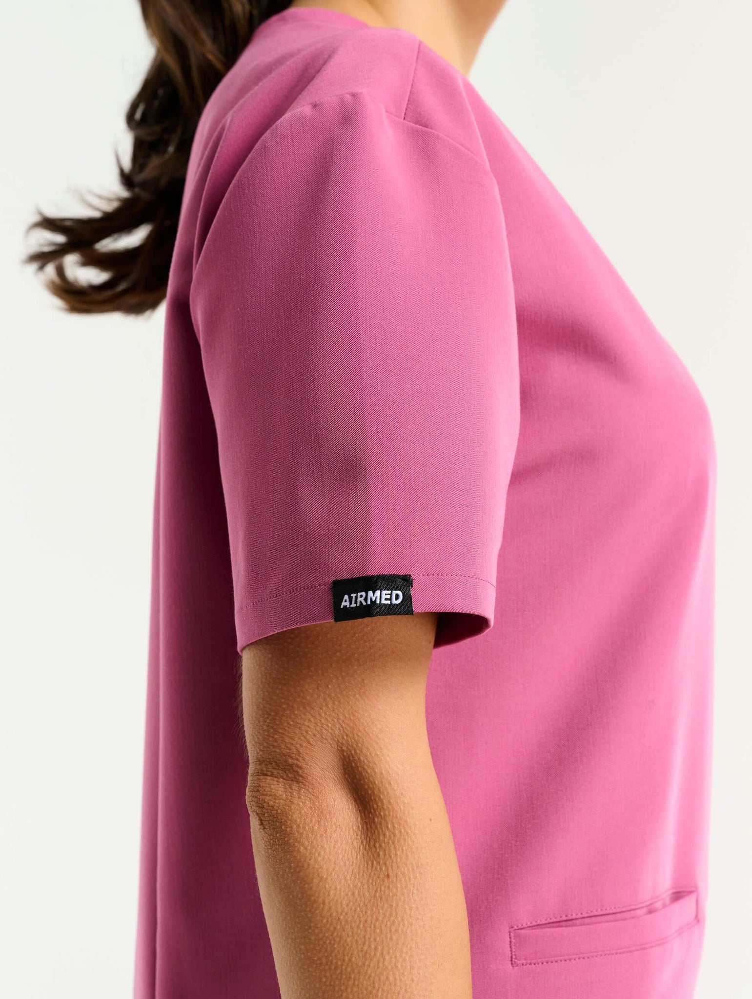 close up of neckline detail of red violet v neck scrub top