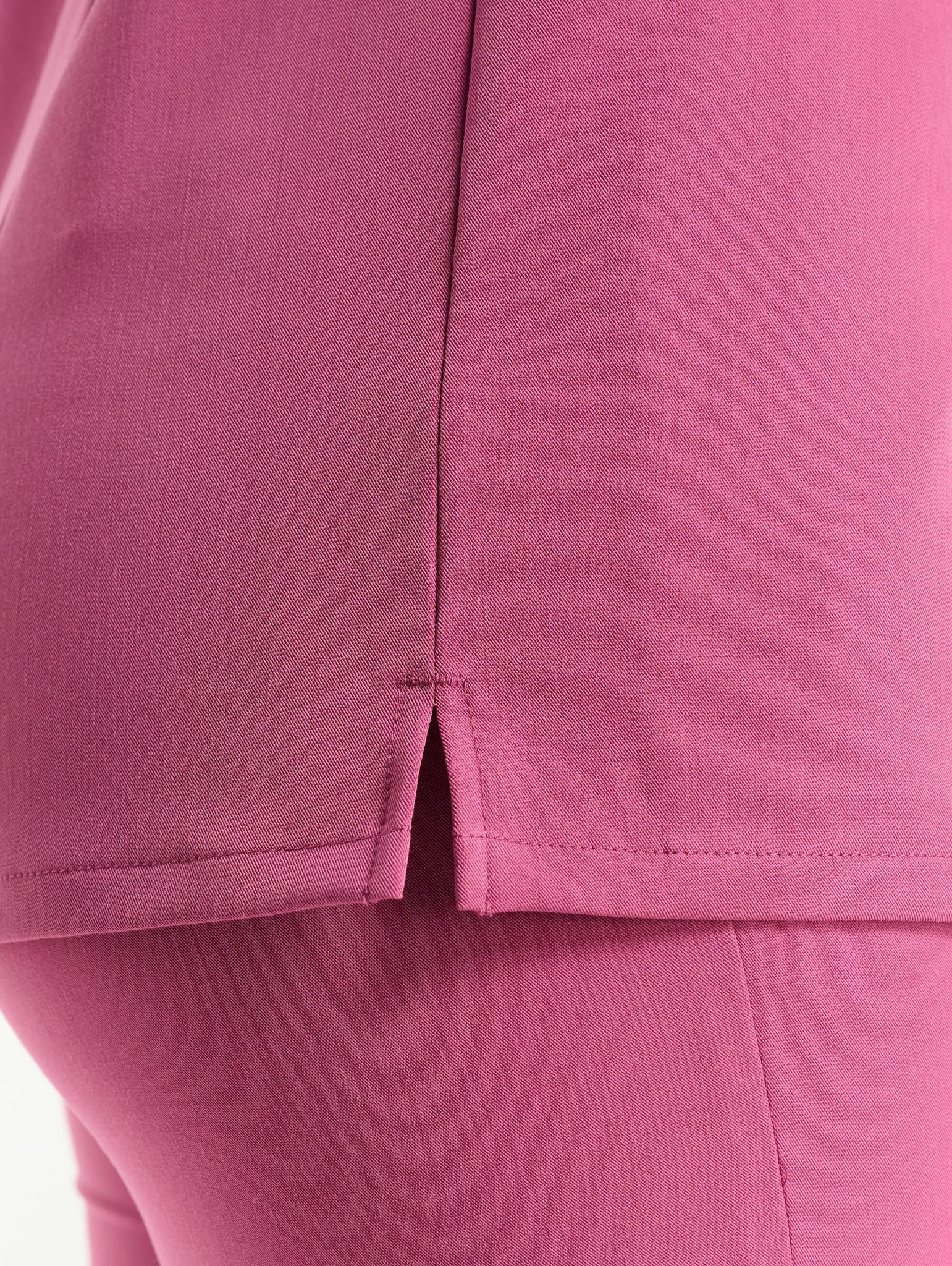 close up of sleeve detail of red violet v neck scrub top