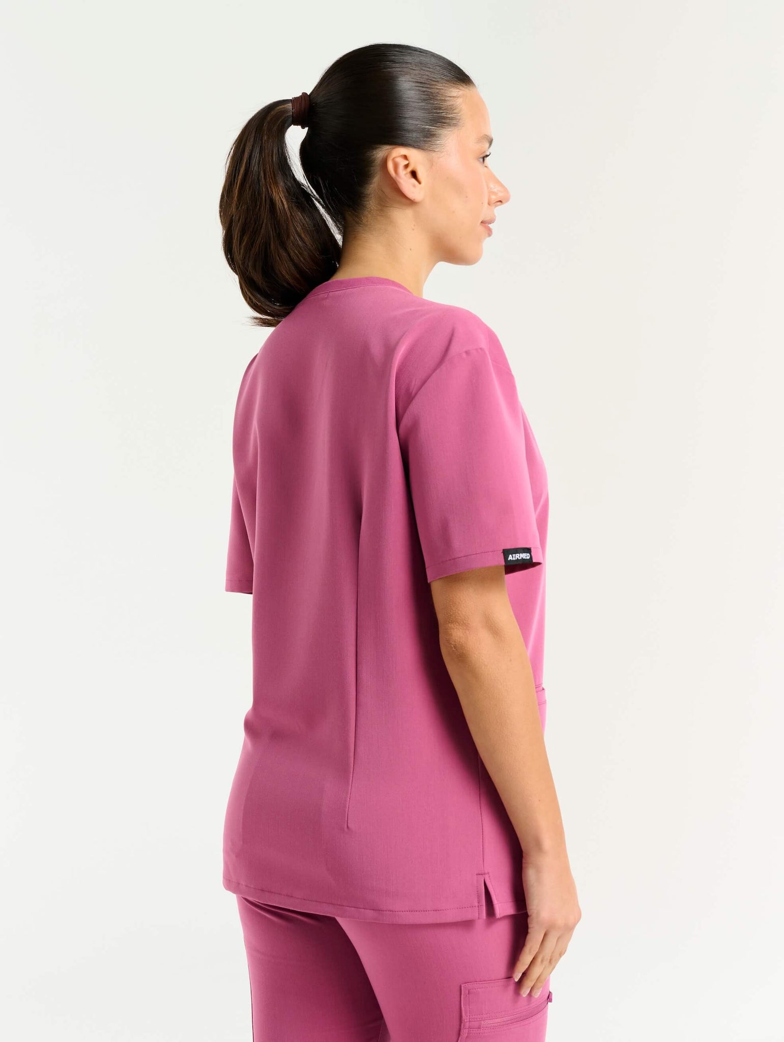 front view with stethoscope of red violet v neck scrub top